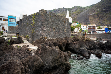 GARACHICO, TENERIFE, SPAIN - JULY 20, 2023: Castle of San Miguel (Castillo de San Miguel) and natural pools of El Caleton. Atlantic ocean.のeditorial素材