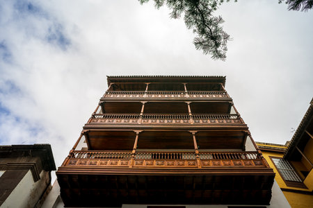 Facade of an old house with beautiful wooden balconies of the old town of Icod de los Vinos, on the northern coast of Tenerife. Canary Islands, Spain.の写真素材