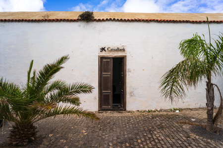 TEGUISE (village), LANZAROTE, CANARY ISLANDS - OCTOBER 26, 2023: Entrance to a CaixaBank branch....