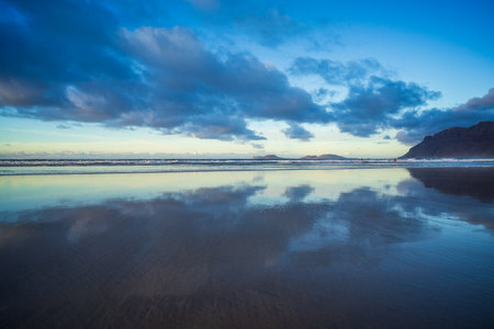 The evening's Famara Beach (Playa de Famara) -  popular surfing beach in Lanzarote. Canary Islands. Spain.の写真素材