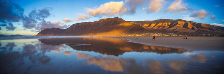 Panoramic view of the evening's Famara Beach (Playa de Famara) -  popular surfing beach in...
