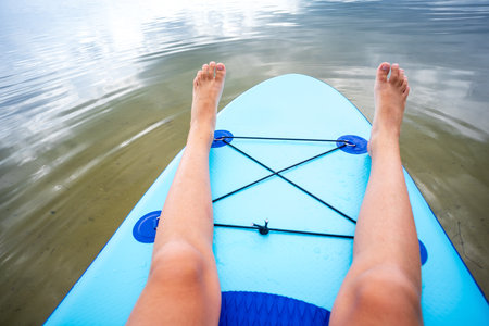 Teenager and SUP board. Active recreation on the Senftenberg lake. Federal land of Brandenburg....
