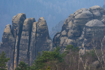 An early morning in mountain. Schrammsteine - group of rocks are a long, strung-out, very jagged in the Elbe Sandstone Mountains located in Saxon Switzerland in East Germany.の写真素材