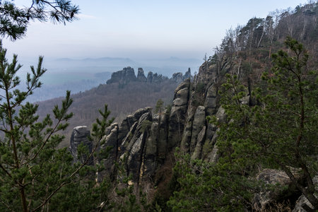 An early morning in mountain. Schrammsteine - group of rocks are a long, strung-out, very jagged in the Elbe Sandstone Mountains located in Saxon Switzerland in East Germany.の写真素材