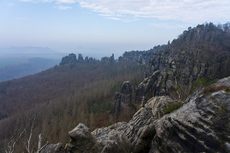 An early morning in mountain. Schrammsteine - group of rocks are a long, strung-out, very jagged in the Elbe Sandstone Mountains located in Saxon Switzerland in East Germany.の写真素材