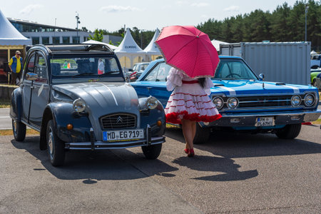 LINTHE, GERMANY - MAY 27, 2023: The mid-size car Plymouth Belvedere GTX and the economy car Citroen 2CV. Die Oldtimer Show 2023.のeditorial素材