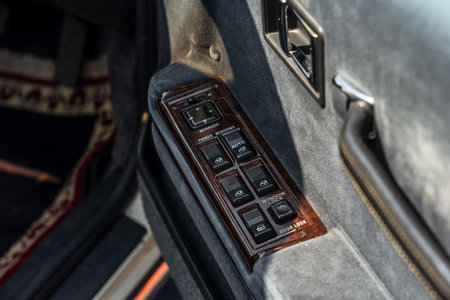 LINTHE, GERMANY - MAY 27, 2023: The buttons for controlling power windows and adjusting rear-view mirrors of executive car Mitsubishi Debonair, 1988. Die Oldtimer Show 2023.のeditorial素材