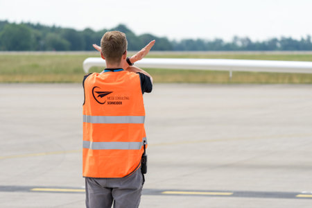 BERLIN - JUNE 07, 2024: Flight safety worker on the airfield. ILA Berlin Air Show.