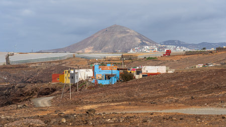 Houses on the northern coast of the Atlantic Ocean. In the background is the extinct volcano Pico de...