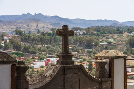 Stone cross and mountain landscape surrounding the picturesque village of Santa Brigida in Gran Canaria. Canary Islands. Spain.の写真素材