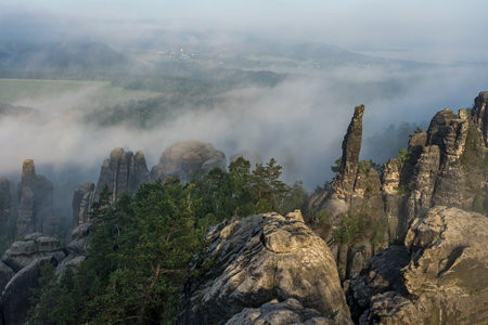 An early morning in mountain. Schrammsteine - group of rocks are a long, very jagged in the Elbe Sandstone Mountains located in Saxon Switzerland in East Germany.の写真素材