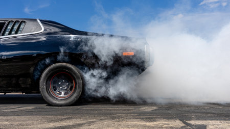 Drifting, with smoke from under the wheels of a sports car. Preparing for the start.