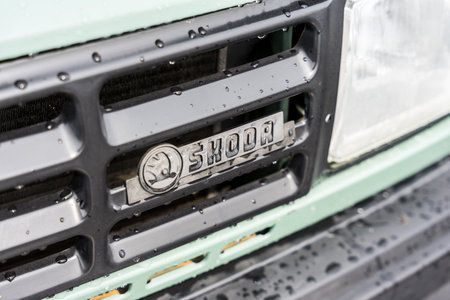 LINTHE, GERMANY - JUNE 08, 2025: The classic Skoda front grille with logo badge in rain on 130 L sedan. Die oldtimer show.のeditorial素材