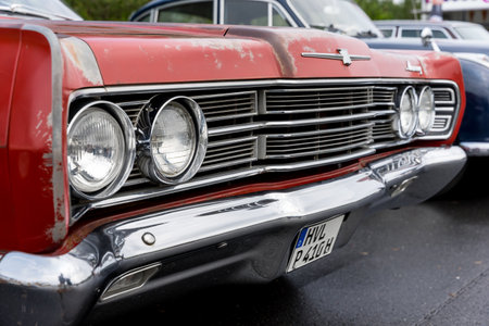 LINTHE, GERMANY - JUNE 08, 2025: The full-size classic Mercury Park Lane Brougham front grille and chrome bumper in red patina. Die Oldtimer Show.のeditorial素材