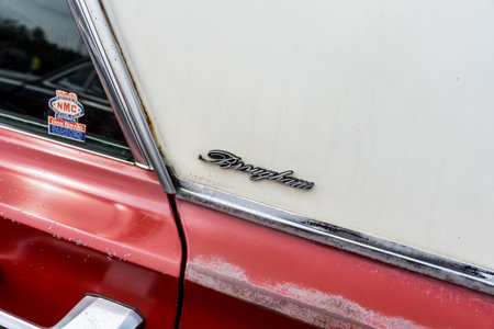 LINTHE, GERMANY - JUNE 08, 2025: The full-size classic Mercury Park Lane Brougham rear pillar fragment with Brougham script badge and red white two tone bodywork in patina. Die Oldtimer Show.のeditorial素材