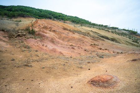 Eroded colored slopes and green forest edge in Upper Teno Moonscape Teno Alto. Tenerife, Canary...