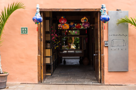 GARACHICO, SPAIN - AUGUST 5, 2025: Entrance of La Quinta Roja hotel decorated with colorful lanterns and plants in historic building facade. Tenerife, Canary Islands.のeditorial素材