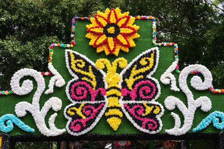 GARACHICO, TENERIFE - AUGUST 5, 2025: Closeup of colorful butterfly and flower motif made from paper flowers on Fiesta de la Muerte festival arch, Canary Islands.のeditorial素材