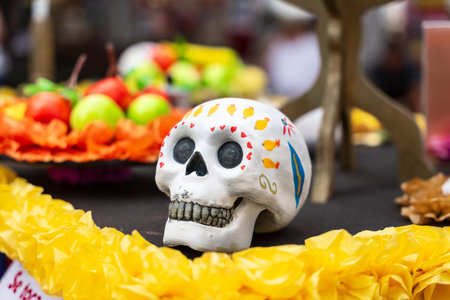 GARACHICO, TENERIFE - AUGUST 5, 2025: Decorative painted skull on altar with yellow paper flowers and colorful festival ornaments during Fiesta de la Muerte, Canary Islands.のeditorial素材