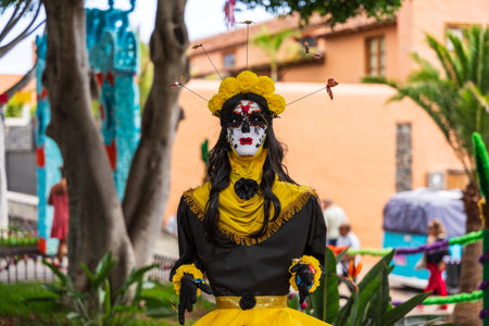 GARACHICO, TENERIFE - AUGUST 5, 2025: Festival mannequin in yellow and black costume with painted...