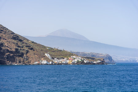 Colorful coastal village of Rojas with white houses clustered on volcanic cliffs, blue Atlantic...
