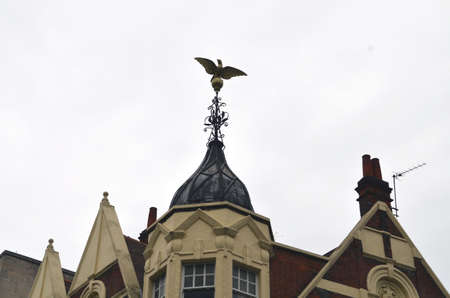 Eagle weather vane in a beautiful sky at a house in londonの写真素材