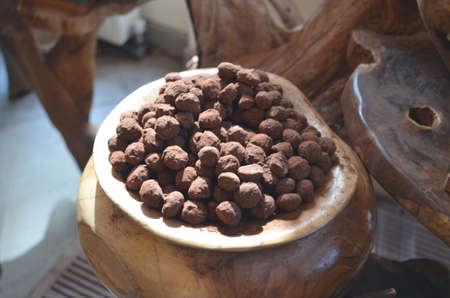 many Chocolate balls on a wooden vatの写真素材