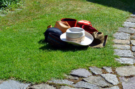 bunch of differtent hats lying in grassの写真素材