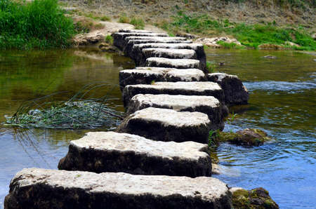 closeup of stepstones crossing a small riverの写真素材