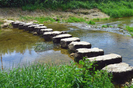 closeup of stepstones crossing a small riverの写真素材
