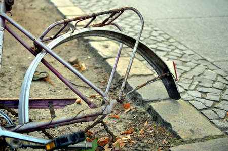 details of old abandoned rusty and broken bike at the street