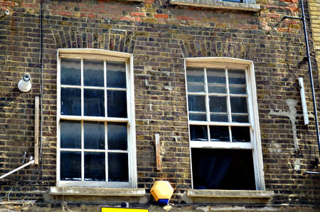 two typical British windows in a brick wall opened and closed, Uk, London
