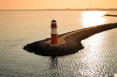 Bright colored sky and smooth colored calm blue waterの写真素材