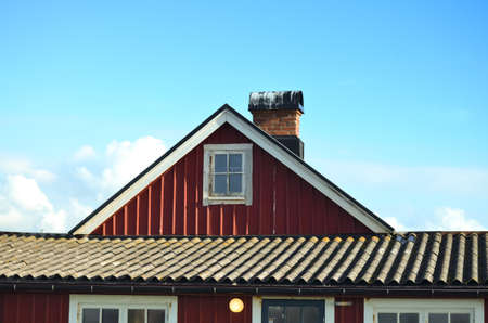 typical swedish falun red house with blue skyの写真素材