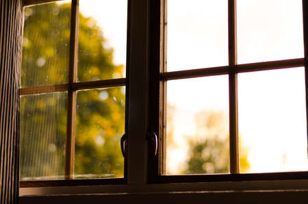 view through wooden window on autumn landscapeの写真素材