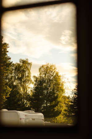 view through wooden window on autumn landscapeの写真素材