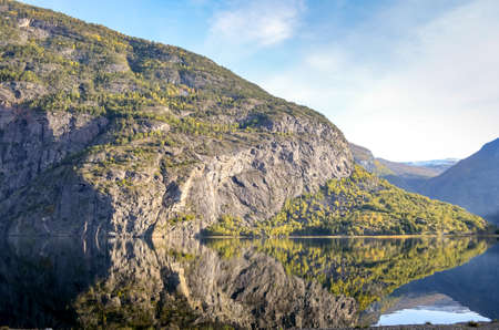 perfect reflection of mountains in clear fjord landscape
