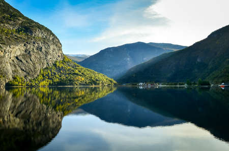 perfect reflection of mountains in clear fjord landscape