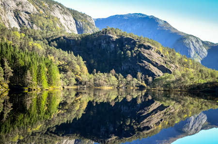 perfect reflection of mountains in norwegian fjordの写真素材