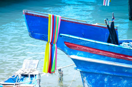 typical colorful thai longtail boat in ocean waterの写真素材