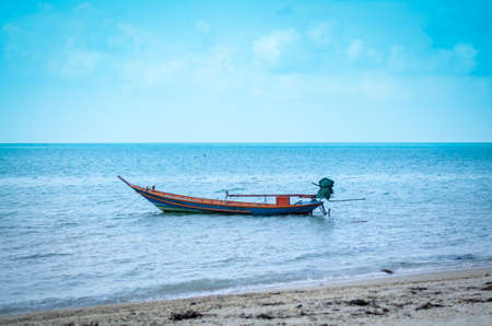 single typical colorful thai longtail boat in ocean water