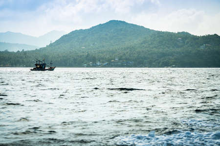 idyllic tropical island alone in blue oceanの写真素材