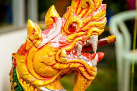 orange dragon as detail in thai buddhistic templeの写真素材