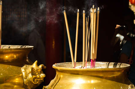 Incense stick in a golden bowlの写真素材