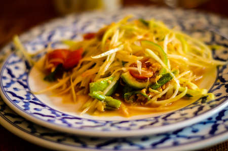 traditional thai papaya salat served on a plateの写真素材