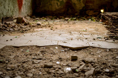 broken floor with cracked tiles in lost abandonend building