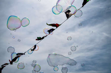 soap bubbles flying in the sky with triangle pennantsの写真素材
