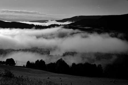 cold morning dust floating over norwegian landscapeの写真素材