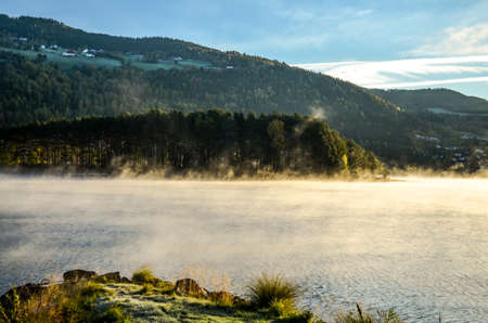 cold morning dust floating over norwegian landscapeの写真素材