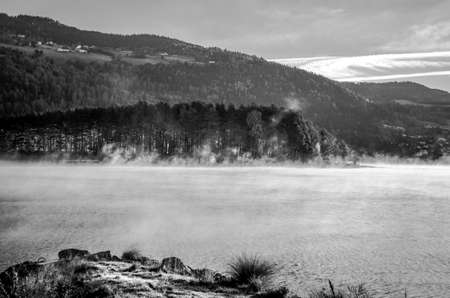 cold morning dust floating over norwegian landscapeの写真素材